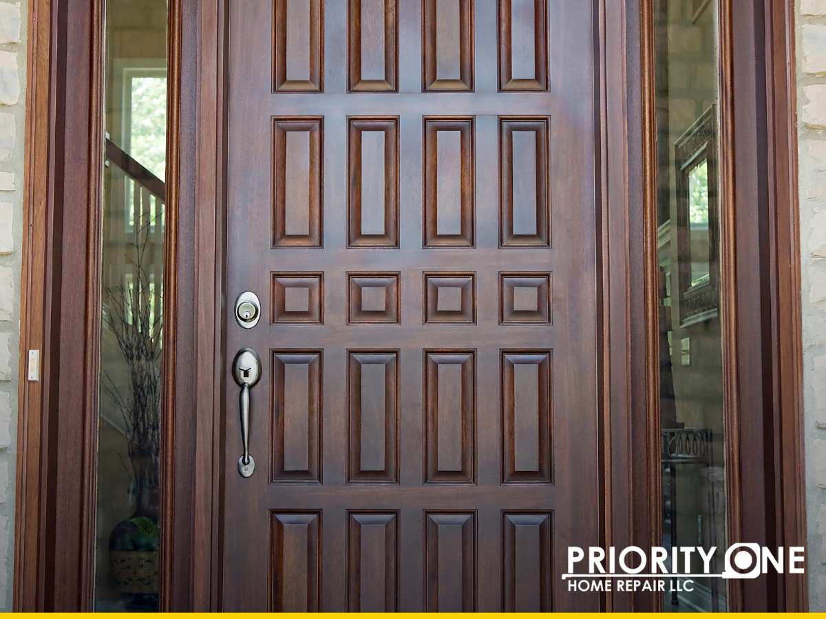 Custom wooden door with intricate panel designs by Priority One Home Repair