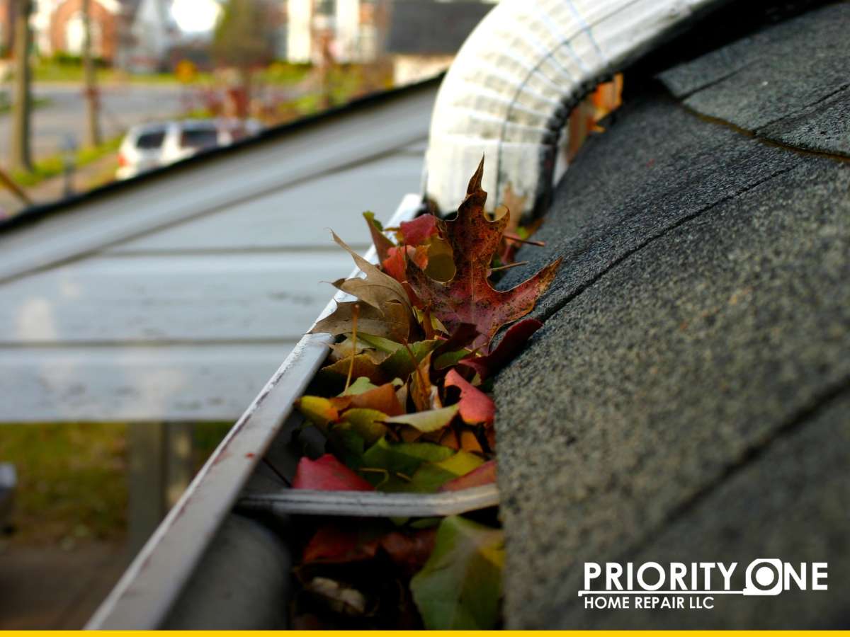 Clogged gutters filled with leaves—essential home projects this fall to prevent water damage